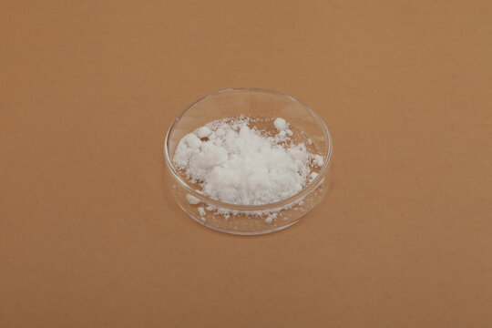 Monopotassium phosphate or Potassium dihydrogen phosphate in Petri dish. Monobasic potassium phosphate. Inorganic compound, chemical formula KH2PO4. Fertilizer increases the yield