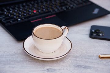 Elegant Coffee Break with Laptop and Smartphone on Minimalist Desk