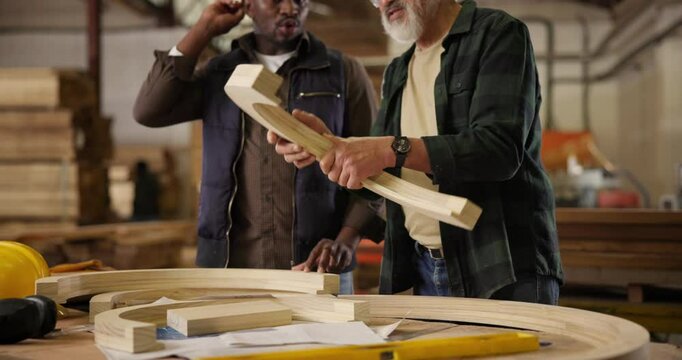 Wood, creative and carpenter planning design in workshop for furniture, manufacturing and drawing with tools. People, measuring and production in factory for project, craft or startup in warehouse