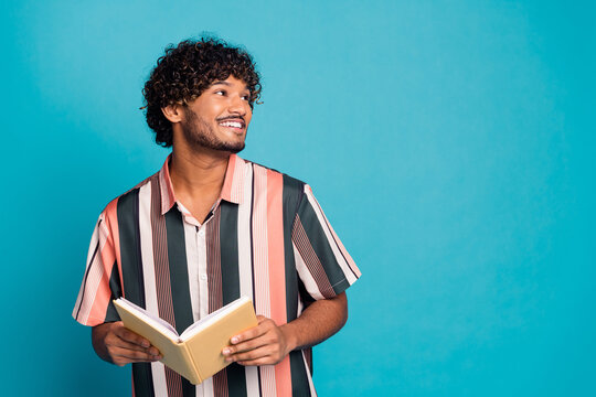Portrait of nice young man book look empty space wear shirt isolated on turquoise color background