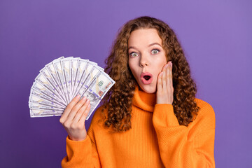 Photo of nice young girl hold money cash wear pullover isolated on violet color background