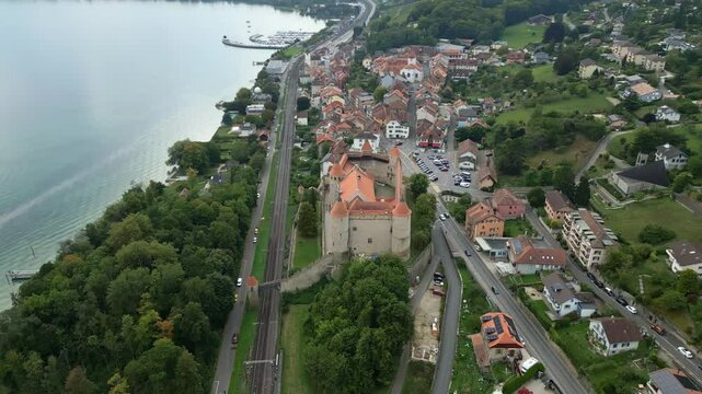 Orbit drone shot of Grandson Castle with Lake Neuchatel behind in Canton of Vaud in Switzerland.