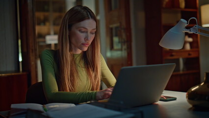 Tired manager working night home looking laptop close up. Woman writing copybook
