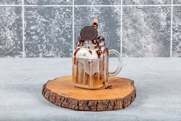 Chocolate milkshake in a jar. Chocolate indulgent extreme milkshake with brownie cake, marshmallow...