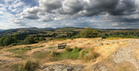 Lonely Bench On Orrest Head Hill In Lake District National Park England Great Britain On A Beautiful Summer Day With A Few Clouds In The Sky