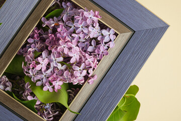 Blue frame mockup with lilac flowers bouquet in beige background, frame mock up with copy space