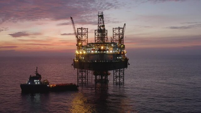 Aerial view of an offshore jack up drilling rig during sunset - oil and gas upstream industry
