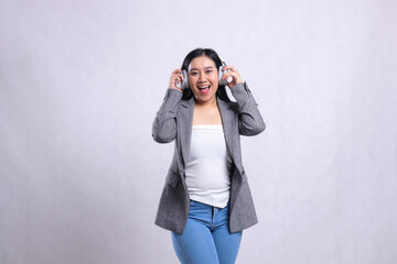 beautiful young female office happy forward holding and wearing headphone headset listening music...