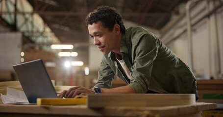 Man, laptop and carpenter, planning and networking in workshop for typing project idea. Male woodworker, communication or read feedback on computer, customer and worker in warehouse for manufacturing - Powered by Adobe