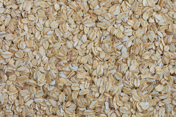 An abstract image of the texture of large oatmeal flakes use for baking and breakfast cereals.