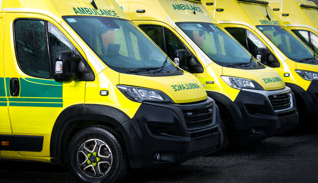 Ambulances - emergency services ambulance vehicles on standby.  The medically equipped transport moves patients with paramedics from scene to a health care facility, such as a hospital, for treatment.