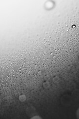 Macro shot of water droplet on reflective surface as background
