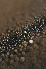 Macro shot of water droplet on reflective surface as background
