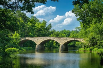 Fototapeta premium Picturesque stone bridge over a serene river