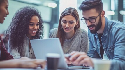 Diverse Group Collaborating on Laptop in Office Setting