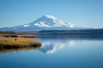 Majestic snow-capped mountain reflected in serene lake
