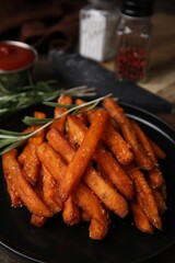 Sweet potato fries and rosemary on table, closeup