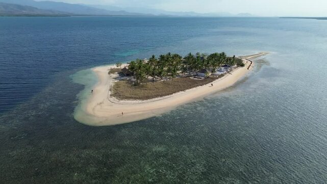 Small island Pulau Bedil, tropical island in Indonesia. Drone view.