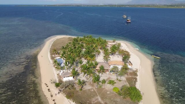 Small island Pulau Bedil, tropical island in Indonesia. Drone view.