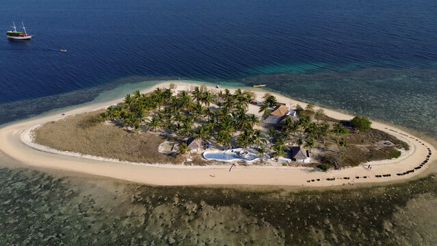 Small island Pulau Bedil, tropical island in Indonesia. Drone view.