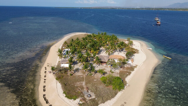 Small island Pulau Bedil, tropical island in Indonesia. Drone view.
