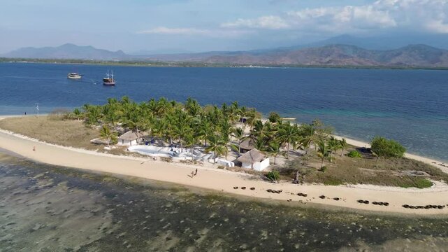 Small island Pulau Bedil, tropical island in Indonesia. Drone view.