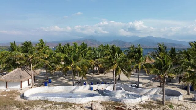 Small island Pulau Bedil, tropical island in Indonesia. Drone view.