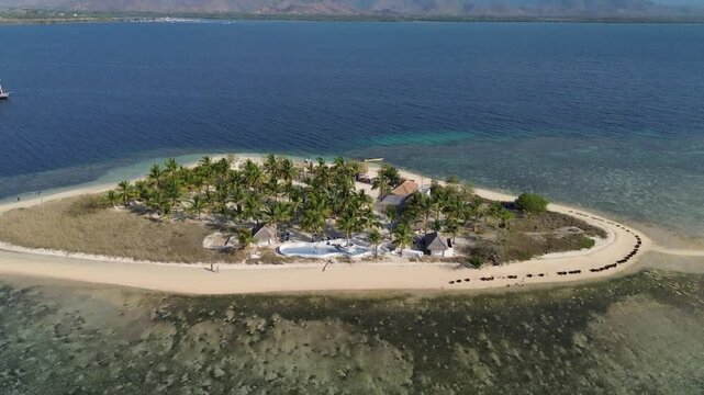 Small island Pulau Bedil, tropical island in Indonesia. Drone view.