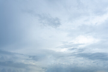 Fluffy white clouds drift across a vibrant blue sky, casting soft shadows on the Earth