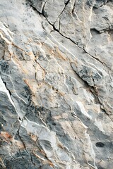 Fototapeta premium A close-up of gray and light beige rock with many cracks and lines.