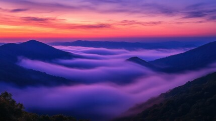 mist rolling over mountain peaks at sunrise