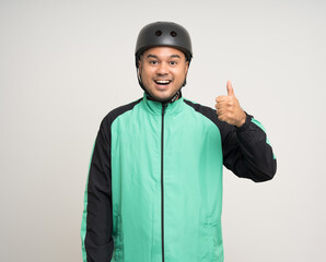 Young asian rider wearing green jacket uniform and bike helmet standing various action on isolated white background. Male delivery service worker. Delivery courier and shipping food service.