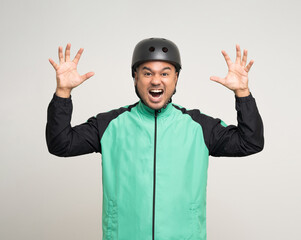 Young asian rider wearing green jacket uniform and bike helmet standing various action on isolated white background. Male delivery service worker. Delivery courier and shipping food service.