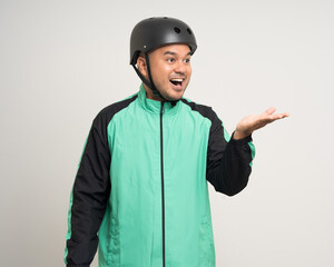Young asian rider wearing green jacket uniform and bike helmet standing various action on isolated white background. Male delivery service worker. Delivery courier and shipping food service.