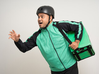 Young asian rider wearing green jacket uniform and bike helmet various action with delivery box. Male delivery service worker. Courier and shipping food service to customer online application