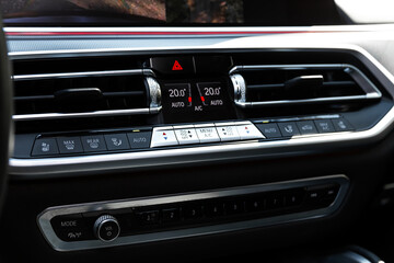 Black car interior: climat control view with air conditioning button inside a car