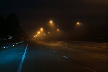 Cars on the road in the fog and drive car carefully.The car is driving along the dangerous foggy...
