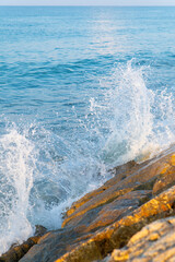 The surf breaks against the rocks on the spit