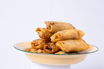 deep-fried chocolate banana on a yellow rustic plate and white isolated background