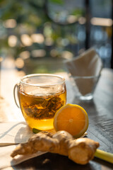 Drink tea at home on sunset. Energy tonic with turmeric, ginger, and lemon. relaxation, home time, sweet home, and break tea time at home.
