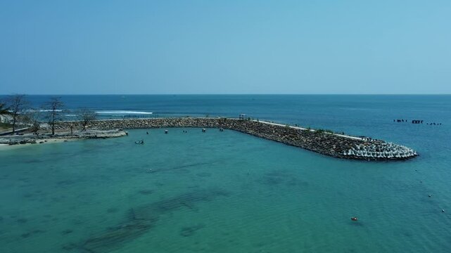 Aerial view of the landmark of Tanjung Lesung beach resort, with blue sky and beautiful blue sea. Aerial drone of La Lassa Beach Club during the day.