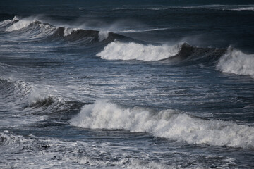 Large storm waves crashing on beach