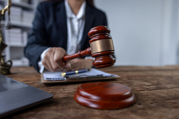 Close up of lawyer or business woman judge working with lawbook in the office or courtroom. gavel...