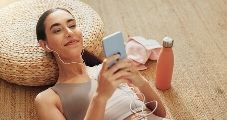 Music, phone and exercise with woman in home for streaming, fitness podcast and peace. Relax,...
