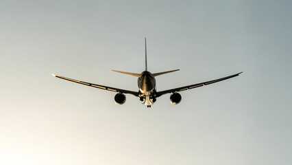 Passenger airliner in the sky at sunset or dawn