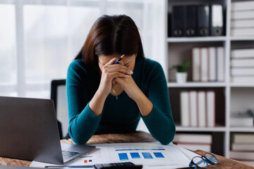 Young woman working on laptop having headache. Bored workaholic female accountant employee with headache and stress. Businesswoman woman with migraine, stress relief, chronic pain
