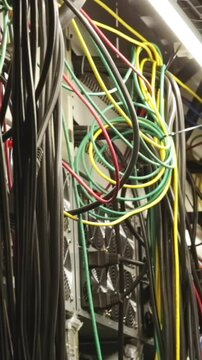 IT professionals concept. Stock footage. Close-up of data center of the large company with lots of fans, system units and wires.