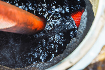 Clogged septic tank. Emptying the septic tank. Pipe in the drainage pit. Sewer cleaning service.