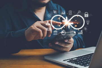Concept of technology data link and global virtual internet connection. Businessman touch virtual infinity with icon showing digital link tech or global networking, digital marketing,big data.