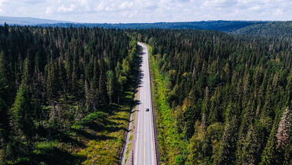 The car is driving along the road